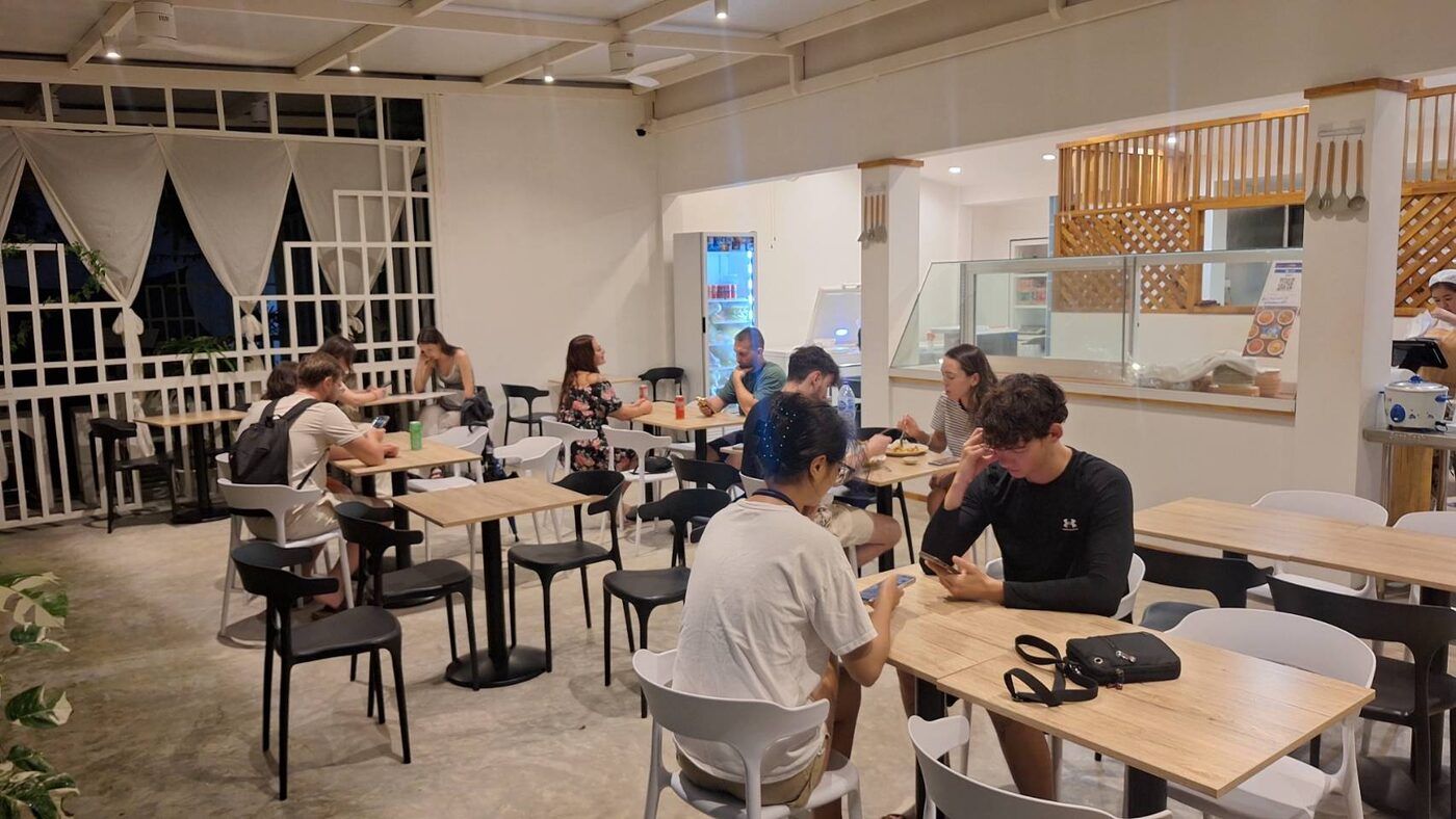 Guests dining inside The Locals halal-certified family restaurant in Tonsai Village